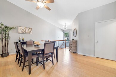 Dining room has vaulted ceiling, ceiling fan with 