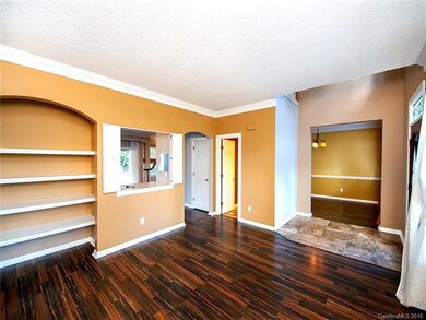 Living room with views to 1/2 bath, foyer & dining
