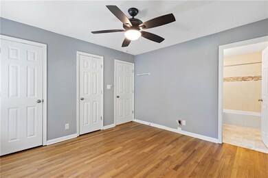 Unfurnished bedroom featuring ensuite bath, basebo
