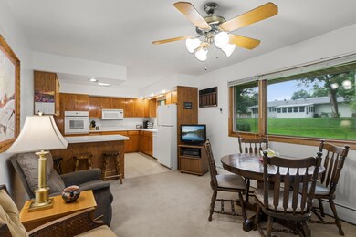 The open kitchen and dining room has large window overlooking the backyard.  Original hardwood awaits underneath the carpeting.