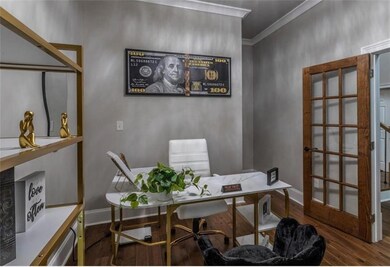 Home office with ornamental molding and dark hardw