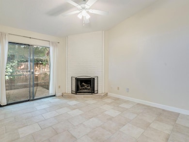 Unfurnished living room with a tiled fireplace, c
