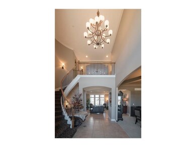 Entry way into home with Curved Staircase.  The ho