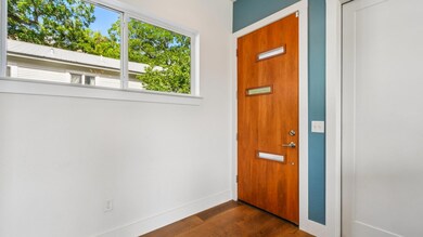 Foyer entrance with dark wood-style flooring and 