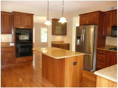 Kitchen. Cherry cabinetry topped with crown moldin