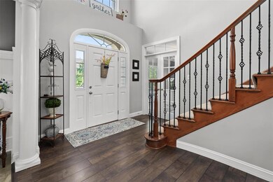 These homeowners have been keeping up with the trends.  Notice the two story foyer with laminate wide plank hardwoods, office with french doors and wrought iron spindles.