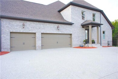 3 Car side entry Garage with extra paved area for parking ~  Covered side patio has entrance to the home without having to go through the garage~