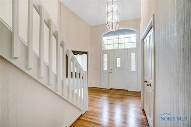 Foyer with High Ceiling, Transom Window and Chandeliere