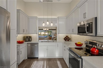 Kitchen featuring quartz counters, pendant lightin