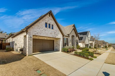 Extended Porte-cochere over garage entrance adds depth to the front elevation of this home.