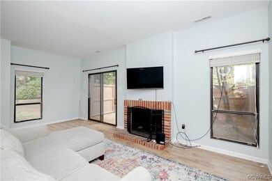 Living room with a wealth of natural light, a fire