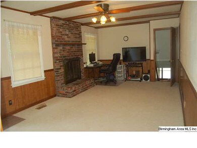 Spacious den on main level with brick wood burning