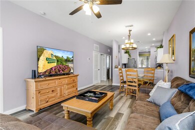 Living room with ceiling fan, wood finished floors