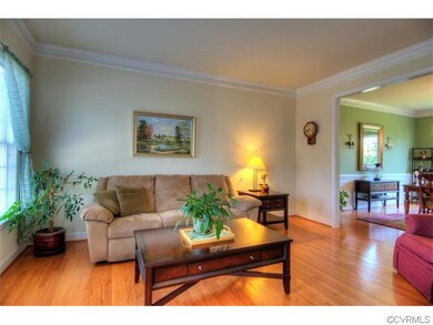 Formal living room with hardwoods and beautiful cr