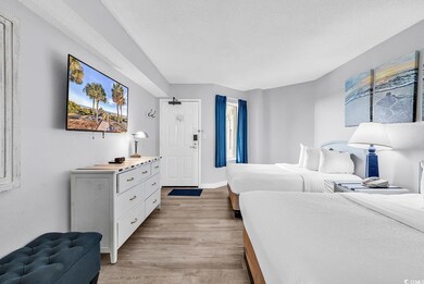 Bedroom with baseboards, a textured ceiling, and l