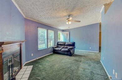 The living room is very spacious and has windows o