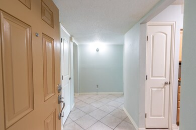 Looking in the front door into the foyer. Kitchen