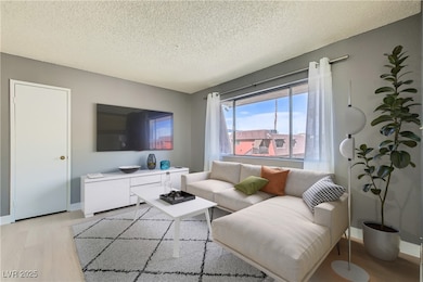Virtually Staged. Living room. Solar shades on win