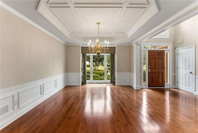2381 Briarleigh Way~ An alternate view of the Dining Room- features a beautiful trey ceiling, wainscotting, and windows overlooking the front.