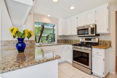 Open and bright kitchen with granite counters, rec