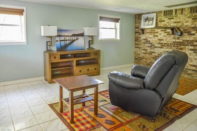 Lower level family room with tile flooring and bri