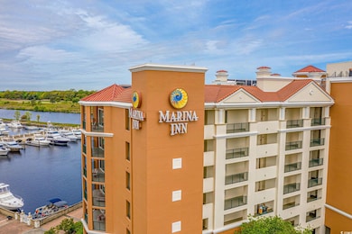 View of apartment building / complex featuring view of marina and a water view