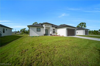 Prairie-style house with concrete driveway, a gara