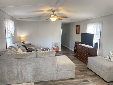 Living room with ceiling fan, dark hardwood / wood