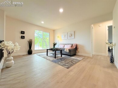 Living area featuring light wood-type flooring, baseboards, and recessed lighting