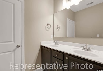 Bathroom with double vanity and tub/shower combination.