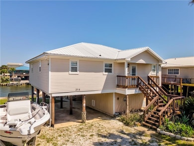 Front of house with a carport, driveway, metal roo
