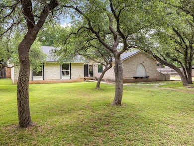 Ranch-style house featuring stone siding