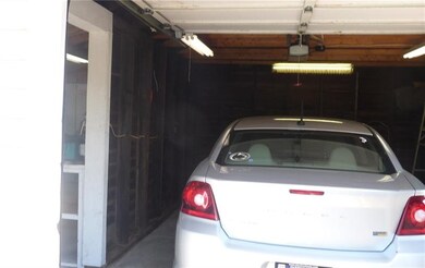 Garage space with auto door opener.