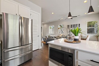 Kitchen with dark wood-style floors, open floor p
