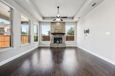 Unfurnished living room with a tray ceiling, ceili