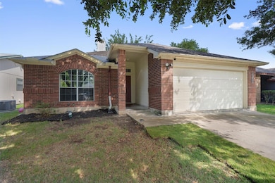 Ranch-style house featuring brick siding, a garag