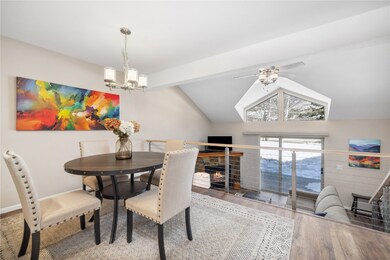 Dining room with lofted ceiling with beams, hardwo