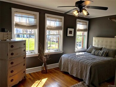 Three large windows in master bedroom with a gorge