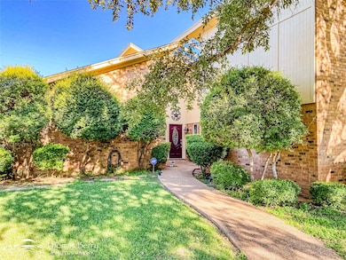 View of front of house featuring brick siding and 