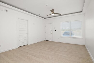 Empty room with light hardwood / wood-style floors and ceiling fan