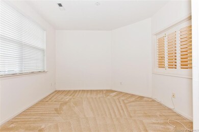 Front room with large window and interior window into living room.  This could be used as a den, formal dining room, office or 3rd bedroom.