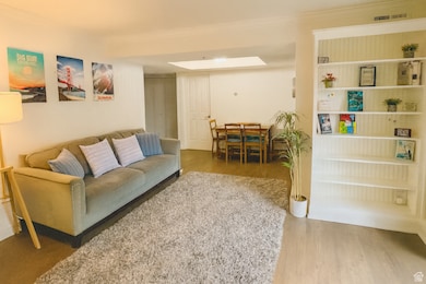 Living room featuring wood finished floors and a skylight