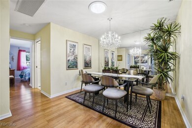 Dining room featuring light wood-style flooring and a chandelier