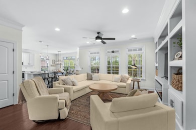 Living area with crown molding, ceiling fan, reces