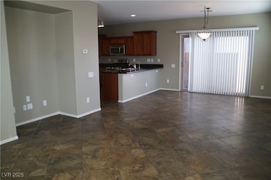 Kitchen with stainless steel appliances, dark coun