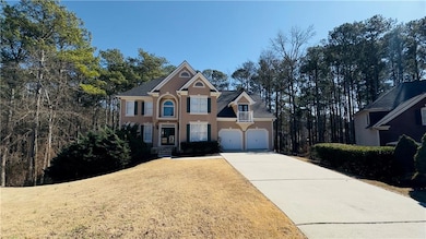 View of front of home featuring stucco siding, driveway, and a garage