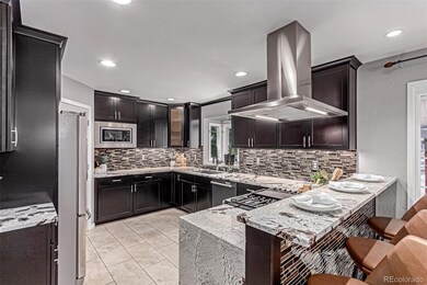 Large peninsula with bar seating and backyard views.