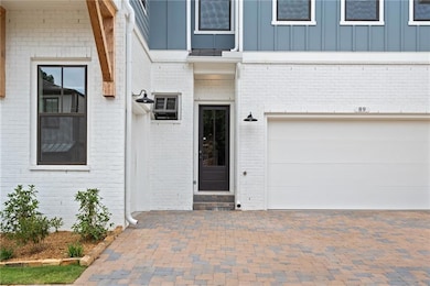 Entrance to property with a garage and a wall unit