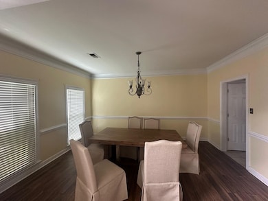 Dining area featuring a chandelier, dark wood-styl