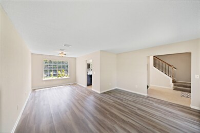 Formal living and formal dining off the entry with update laminate flooring.